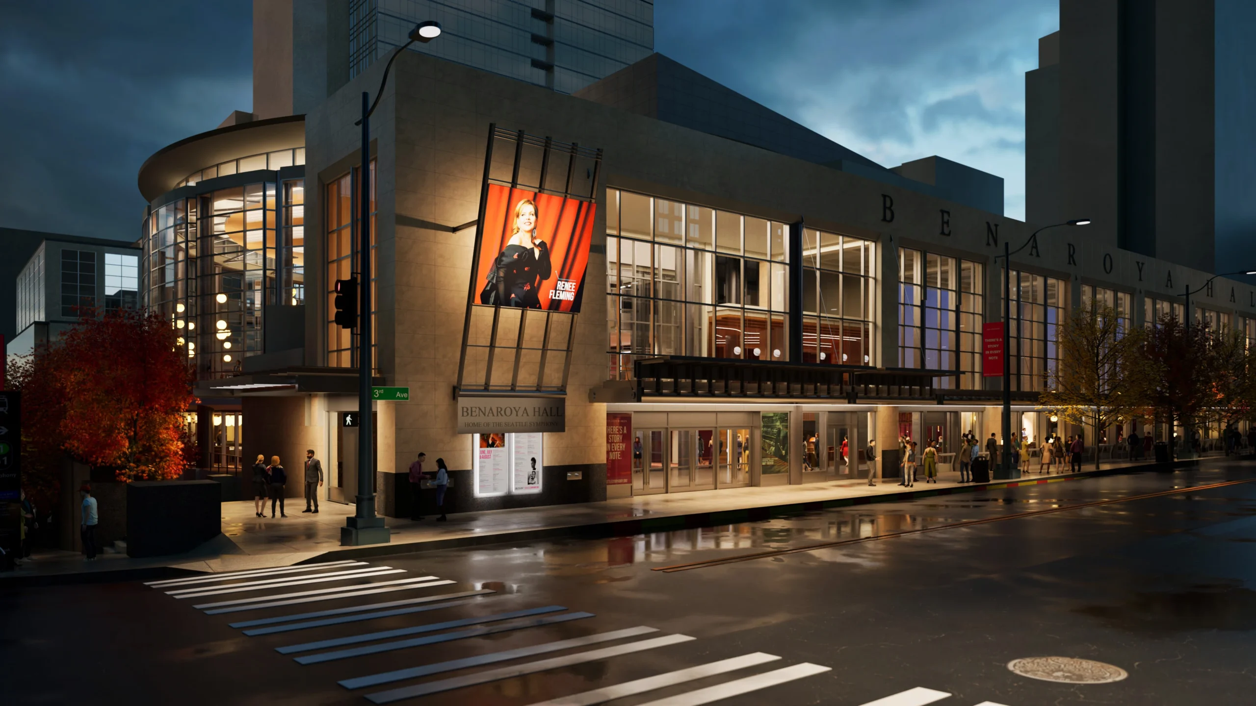 Evening view of Benaroya Hall with a glass façade, street lamps, pedestrians, and a large poster of Renee Fleming.
