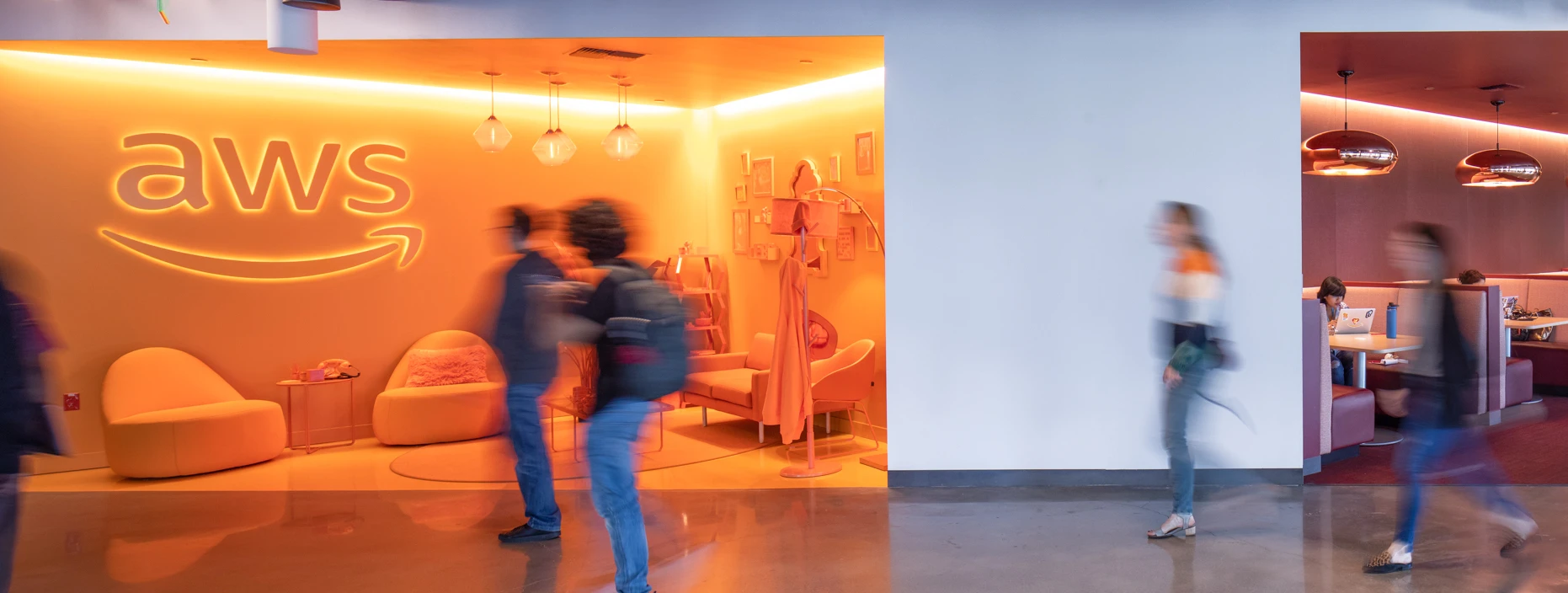 Amazon re:Invent entrance hallway with seating booths and aws vignette